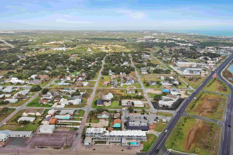 Aerial view of Blue Wave Inn and the neighborhood approaching the coast
